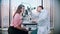 Ophthalmology - a doctor checking young pretty woman visual acuity with a special equipment in the spacious cabinet on