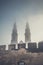 Opole Cathedral towers in the fog behind the walls in Opole, Poland