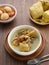 Opor Ayam, Indonesian traditional food in white bowl on wooden table.