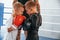 Opponents looking in each other`s eyes before the round starts. Young tattooed coach teaching the kids boxing techniques