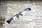 optical eyeglasses lie on the newspaper with English fonts,toned
