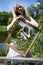 Optical illusion. The composition of an infinite image in a picture. A girl with blond hair on the lake shore holds a picture with