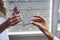 Optician hand giving glasses to woman in optical shop