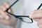 Optician man checking a pair of eyeglasses