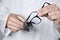 Optician man cleaning a pair of eyeglasses