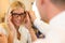 Optician or optometrist consulting a customer about eyeglasses