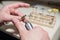 An optician technician polishes the frame of glasses. A professional optician fixes glasses.