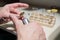 An optician technician polishes the frame of glasses. A professional optician fixes glasses.