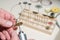 An optician technician polishes the frame of glasses. A professional optician fixes glasses.