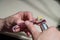 An optician technician polishes the frame of glasses. A professional optician fixes glasses.