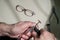 An optician technician polishes the frame of glasses. A professional optician fixes glasses.