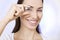 Optics and Glasses, Portrait of young smiling woman looking through her glasses