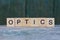 Optics word made from brown wooden letters