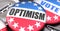 Optimism and elections in the USA, pictured as pin-back buttons with American flag, to symbolize that Optimism can be an important