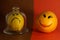 Optimism and pessimism concept. lemon with a sad smiley face and orange with a cheerful smiley