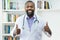 Optimistic african american doctor with beard and stethoscope