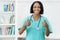 Optimistic african american mature nurse showing both thumbs up