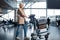 Optimistic aged lady is going through waiting hall with luggage