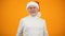 Optimistic aged man in santa claus hat smiling on camera, new year celebration