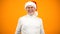Optimistic aged man in Santa Claus hat smiling on camera, new year celebration