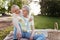 Optimistic aging couple sharing positivity at the picnic