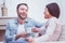 Optimistic bearded man smiling broadly while talking with his wife