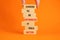 Optimistic is better symbol. Wooden blocks with words Choose to be optimistic it feels better. Beautiful orange background copy