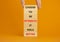 Optimistic is better symbol. Wooden blocks with words Choose to be optimistic it feels better. Beautiful orange background copy