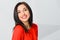 Optimistic brunette girl dressed in red with perfect smile