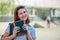 Optimistic Caucasain girl blinks with one eye and smiles. Schoolgirl holds books in hand. Girl with a school backpack