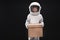 Optimistic cute child astronaut is keeping carton