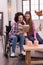 Optimistic disabled woman and girl reading together