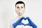 Optimistic doctor in protective mask making heart. Healthcare, medicine and treatment concept