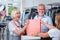 Optimistic elderly couple expressing gratitude for nice purchase