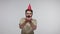 Optimistic joyful bearded guy with funny cone hat laughing and blowing confetti glitters, celebrating birthday