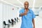 Optimistic mature adult african american male nurse at vaccination station for vacinating patients