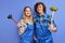 optimistic team of plumbers dressed in blue uniform with plunger, being glad to repair bathtub