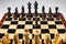 The option proposed by the Australian radio station, Black goes first. Wooden chess. Chess pieces are located on a chessboard. A