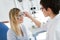 Optometrist checking patient eyesight and vision correction