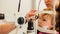 Optometrist checks girl`s eyesight - mother and child have consultation in ophthalmologist room