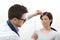 Optometrist examining eyesight, woman patient pointing at the sp