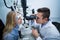 Optometrist examining female patient on slit lamp