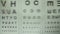 Optometrist performing vision test, choosing lenses for glasses