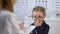 Optometrist prescribing glasses to upset child, eye treatment recommendations