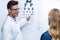 Optometrist taking eye test of female patient