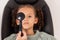 Optometry, eye care and girl getting a vision test with a occluder in a medical optical clinic. Checkup, optometrist and