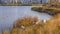 Oquirrh Lake with buildings near grassy lakeshore