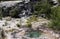 Orakei Korako hidden geothermal valley: View on cascade with steaming hot clear blue alkali chloride thermal pool