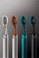 Oral Care Concepts. Closeup Image of Four Spare Attachments for Electric Toothbrush On Black Surface. AI Generated