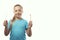 Oral hygiene. Cute Caucasian little girl holding bamboo and plastic toothbrushes in her hands. White background, place